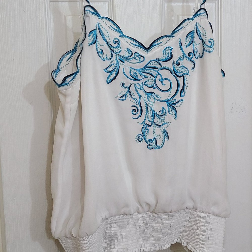 White silky blouse with blue embroidery
